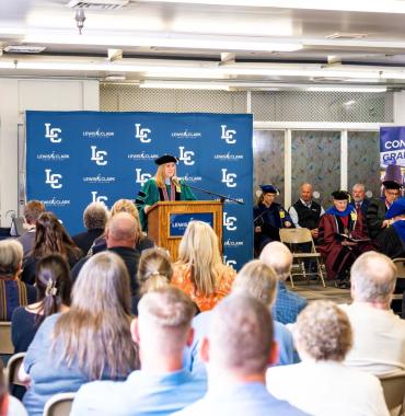 Graduation speaker at podium in front of an audience