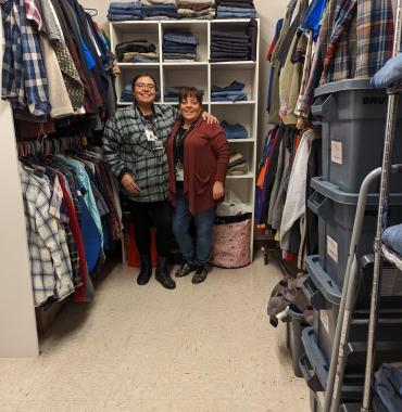 April and Christine stand for photo in "closet"